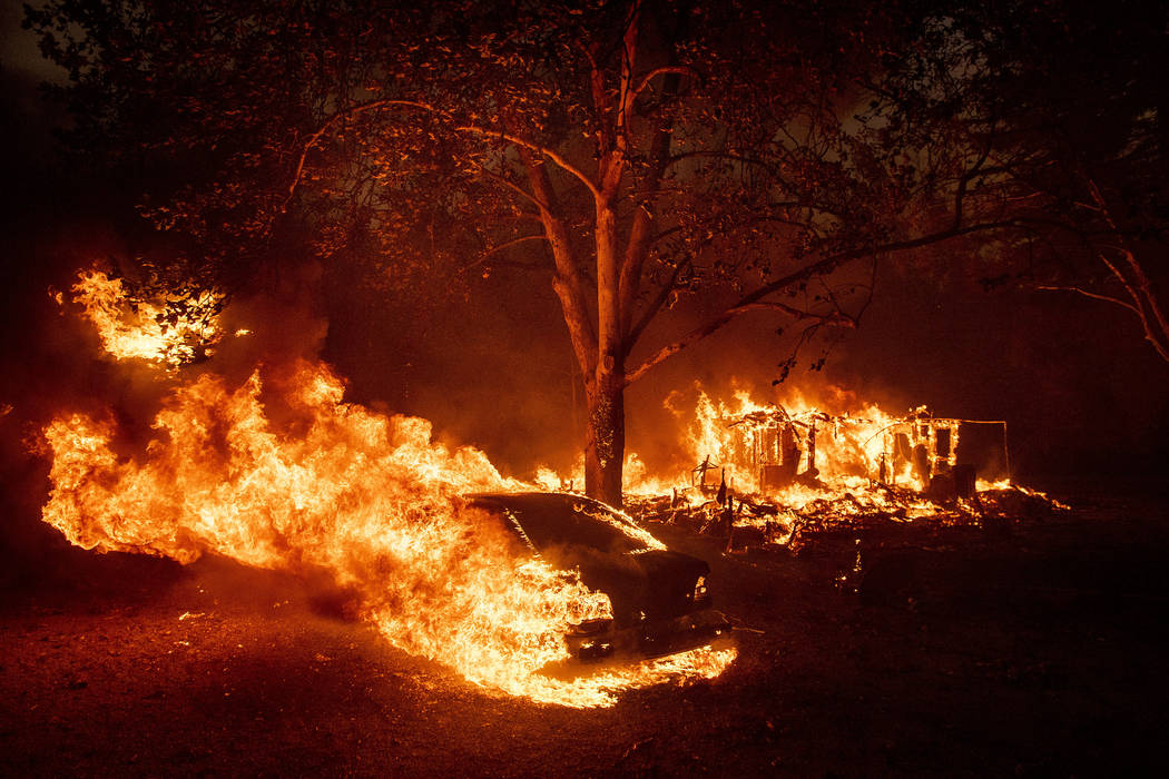 Flames from the Kincade Fire consume a home and car in the Jimtown community of unincorporated ...