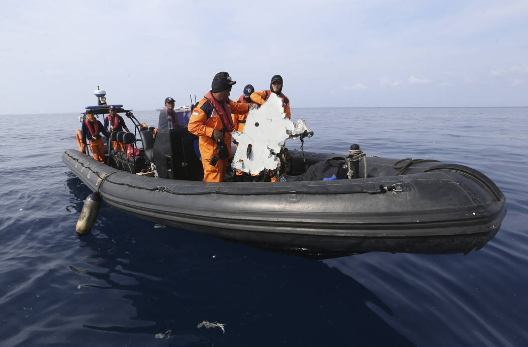 FILE - In this Oct. 29, 2018, file photo, rescuers recover a piece of airplane part from Lion A ...