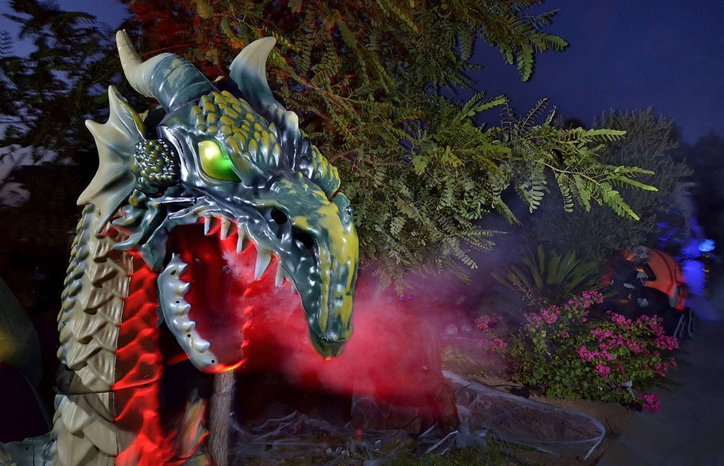 A fire-breathing dragon is part of Carmine Vento's Halloween display. (Bill Hughes Real Estate ...