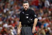 In this Sept. 13, 2019, file photo, umpire Rob Drake stands on the field during a baseball game ...