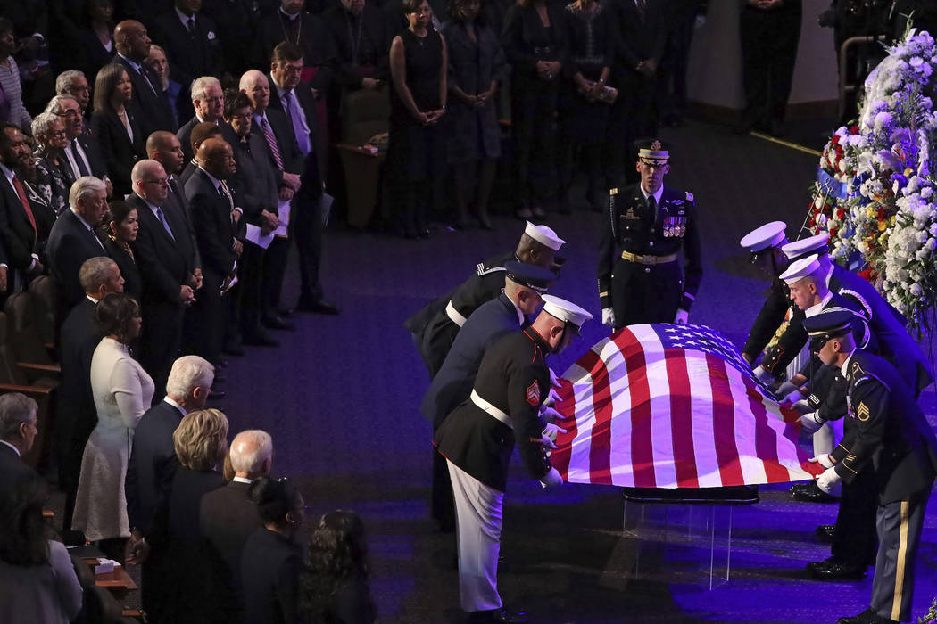 A military honor guard lays a U.S. flag on the casket of Rep. Elijah Cummings, D-Md., during hi ...