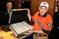 Jim “Mattress Mack” McIngvale holds a suitcase full of cash before making a $3.5 million wa ...