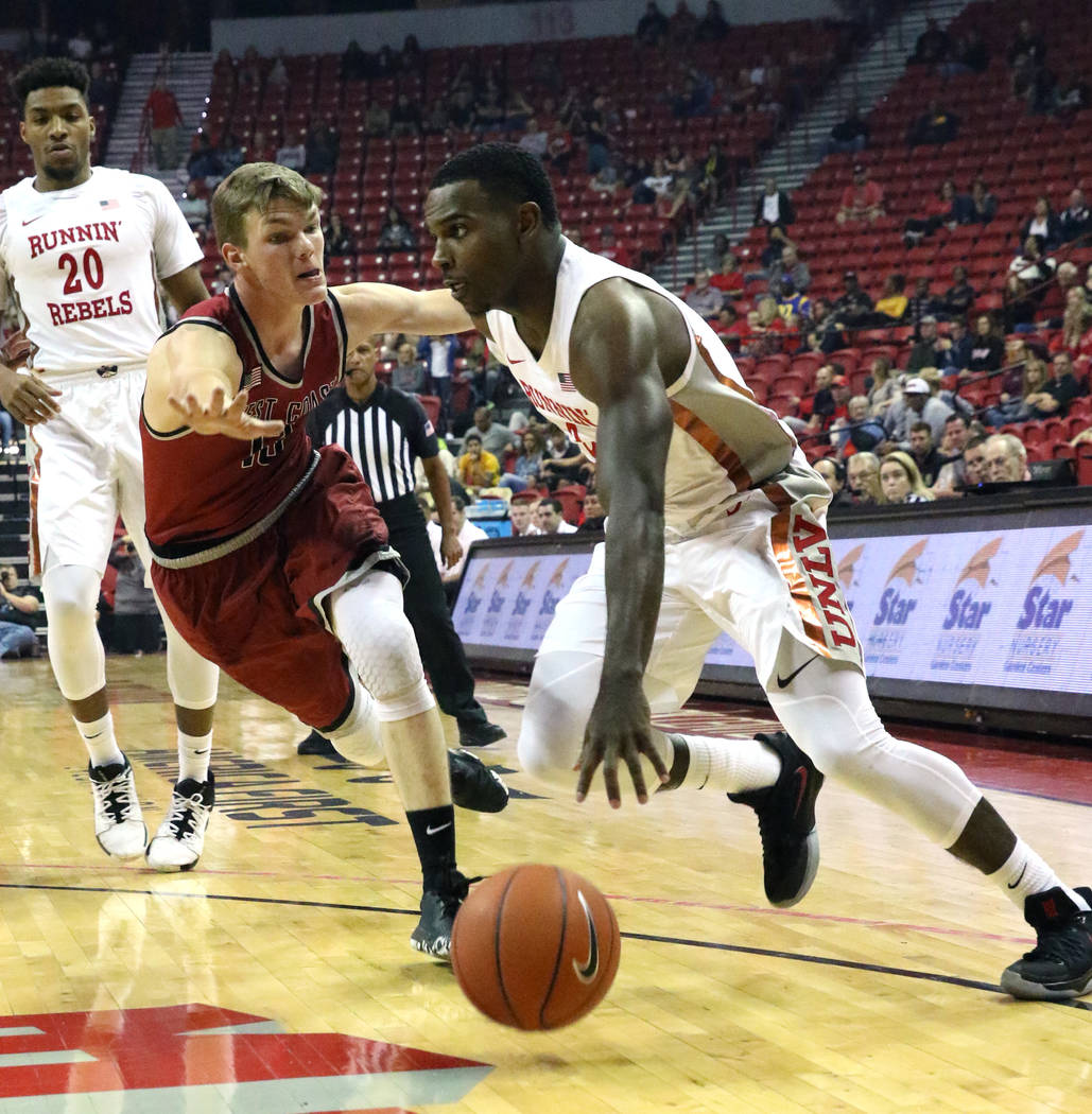 UNLV's guard Amauri Hardy drives past West Coast Baptist guard Andy Gilmer during the first hal ...