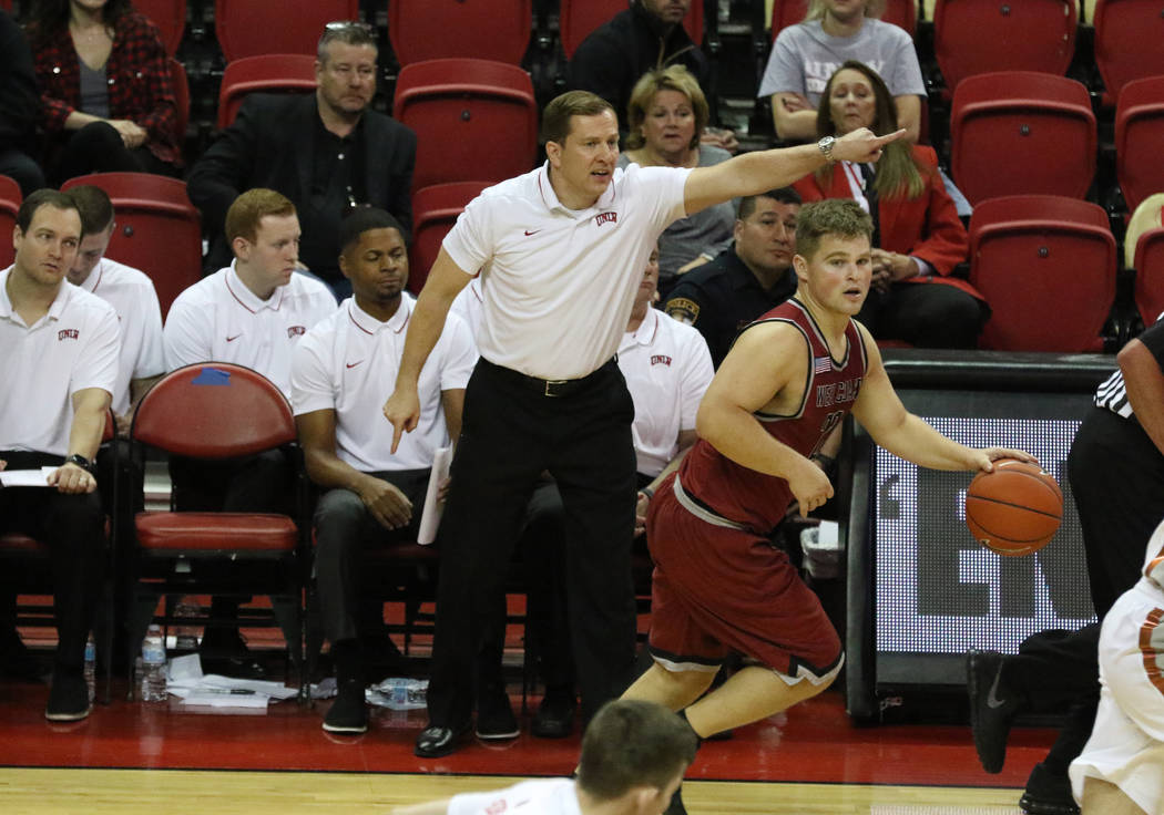 UNLV's basketball head coach T.J. Otzelberger directs his players during the second half of the ...
