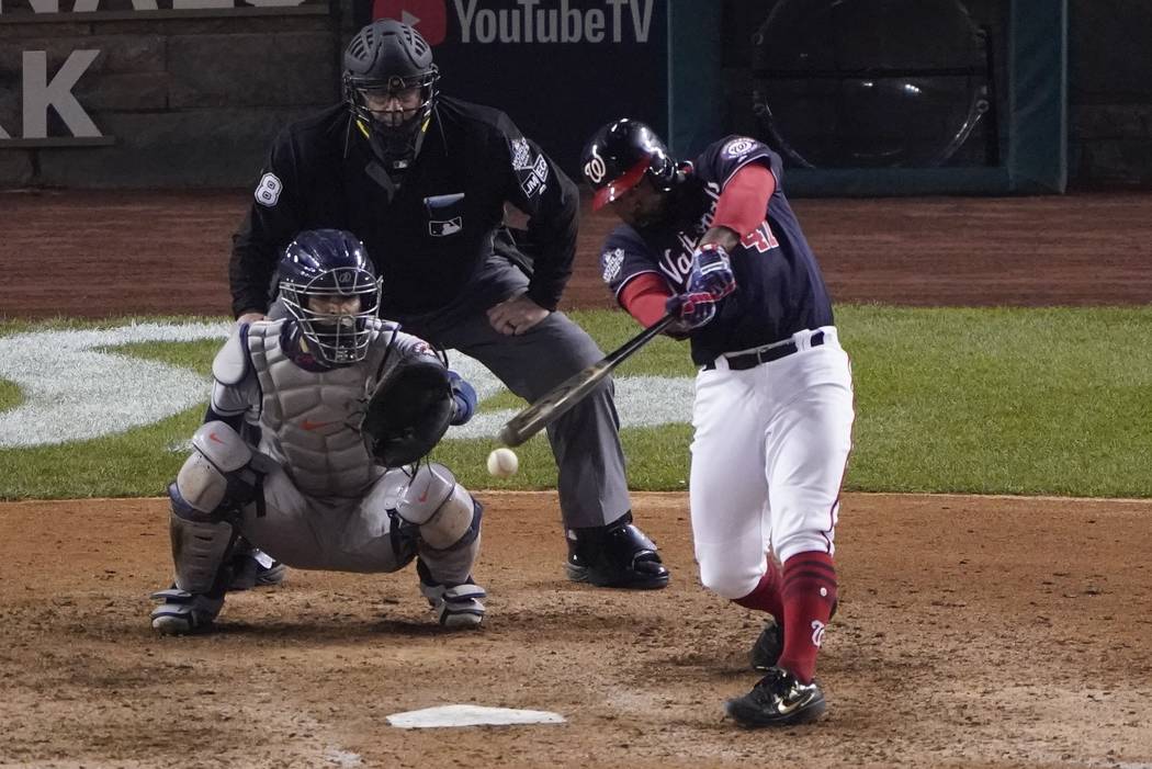 Washington Nationals' Howie Kendrick hits a single during the eighth inning of Game 3 of the ba ...