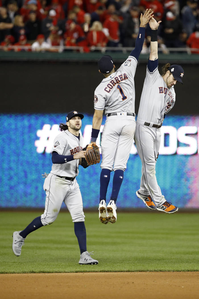 Houston Astros right fielder Josh Reddick, right, celebrates after their win against the Washin ...