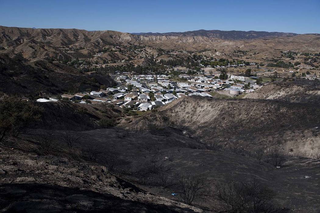 A mobile home community sits between charred hillsides from the Tick Fire, Thursday, Oct. 25, 2 ...