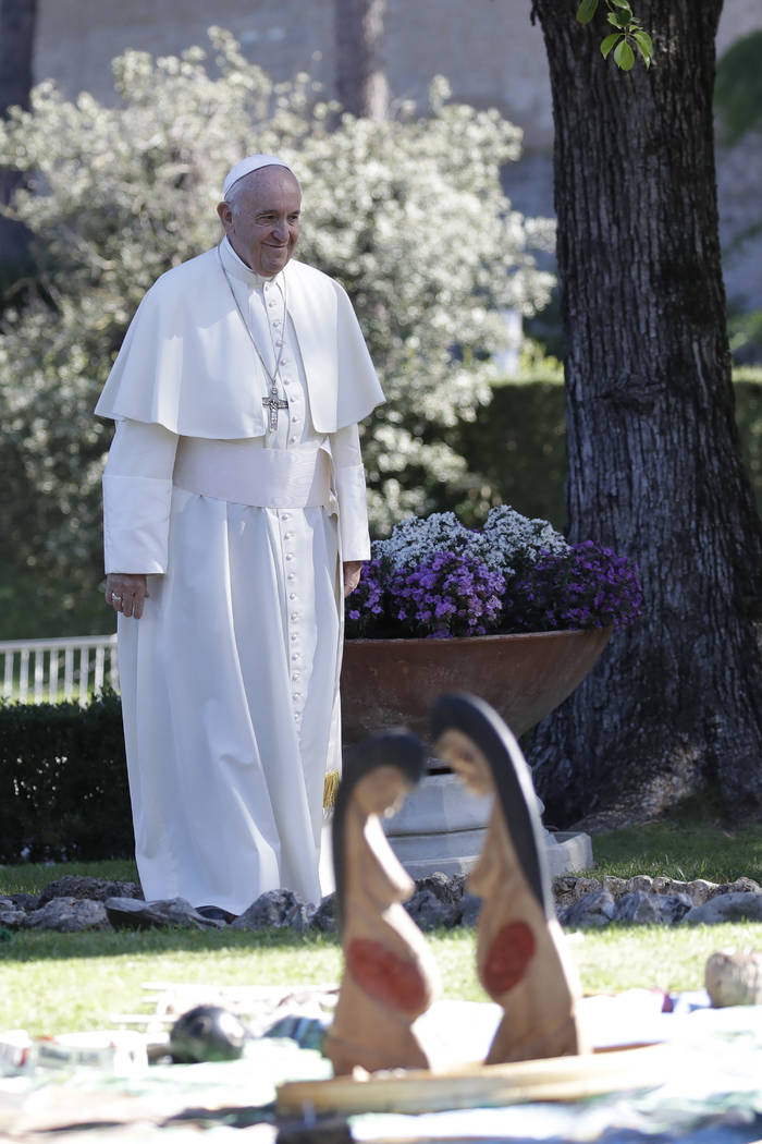 In this photo taken on Friday, Oct. 4, 2019, Pope Francis walks past wooden statues portraying ...