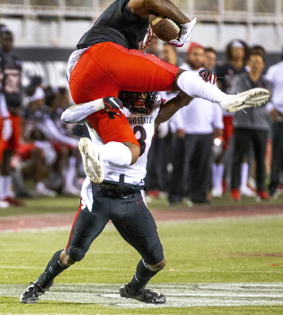 UNLV Rebels tight end Noah Bean (11, above) attempts to go over San Diego State Aztecs cornerba ...