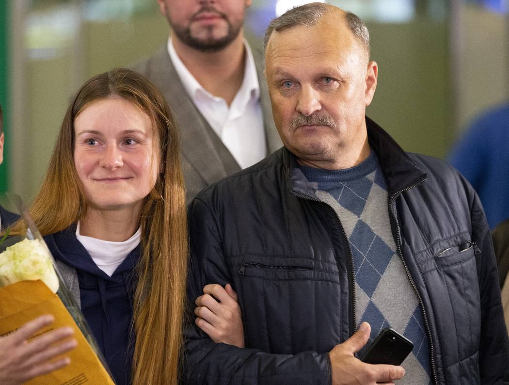 Russian agent Maria Butina, and her father Valery walk upon her arrival from the United States ...