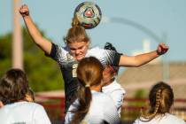 Faith Lutheran's Amelia McManus (20) heads the ball away from Arbor View defenders during the f ...