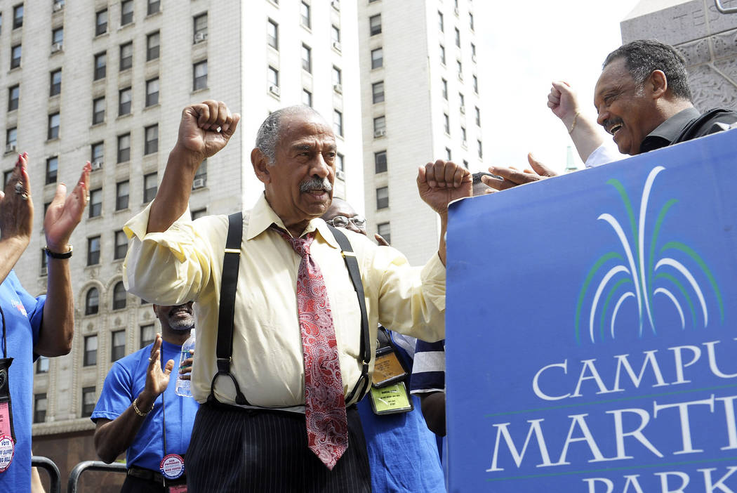 FILE - In an Aug. 24, 2010 file photo, Congressman John Conyers, left, greets the Rev. Jesse Ja ...