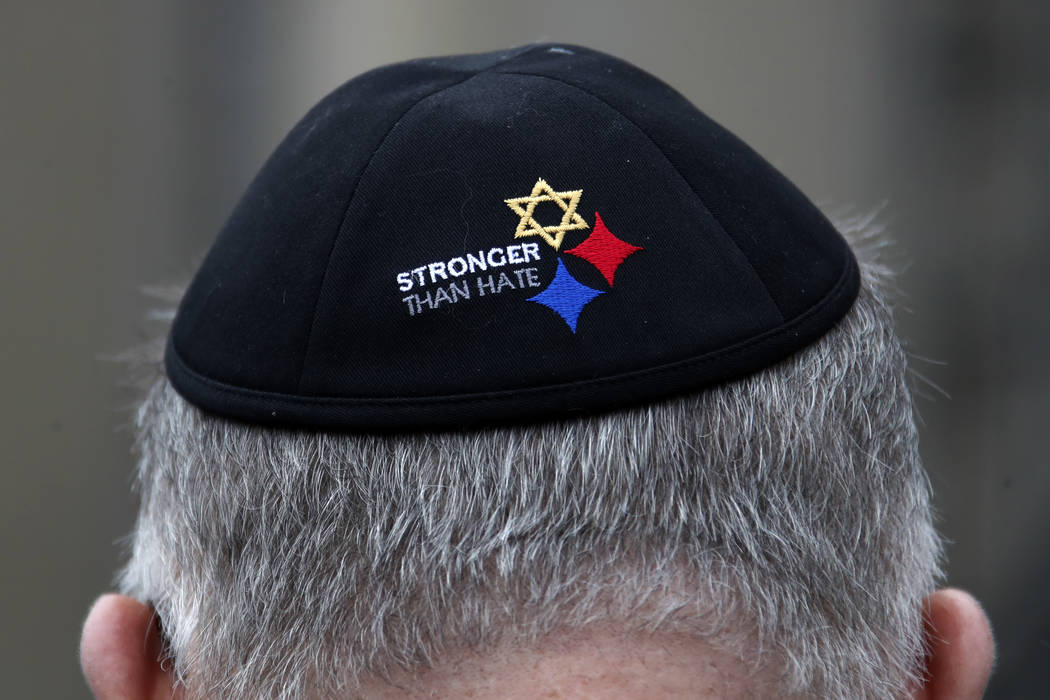 A man wearing a Stronger Than Hate Yamulke stands outside the Tree of Life synagogue in Pittsbu ...