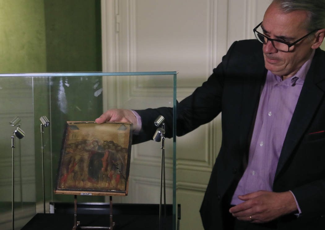 FILE - In this Tuesday, Sept. 24, 2019 filer, art expert Stephane Pinta takes out of a glass ca ...