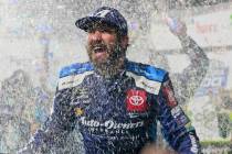 Martin Truex Jr. is doused with water and confetti after winning a NASCAR Cup Series race at Ma ...