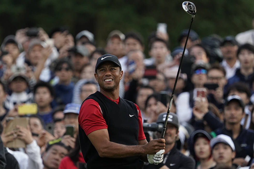 Tiger Woods of the United States watches his tee shot on the 8th hole during the final round of ...