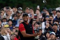 Tiger Woods of the United States watches his tee shot on the 8th hole during the final round of ...