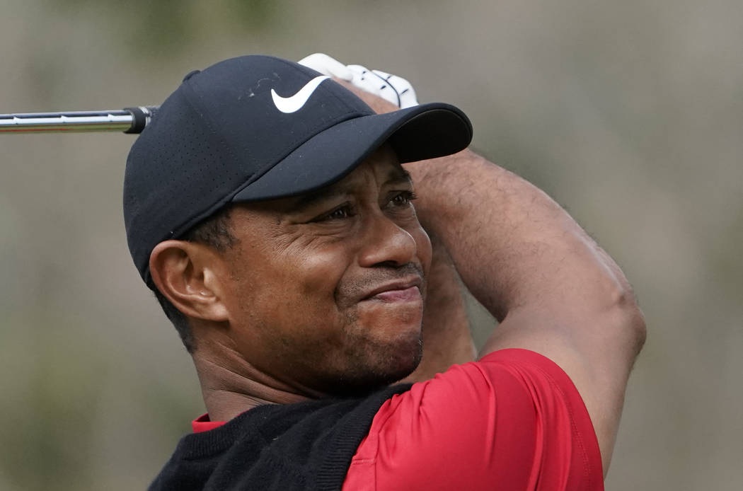 Tiger Woods of the United States watches his tee shot on the 2nd hole during the final round of ...