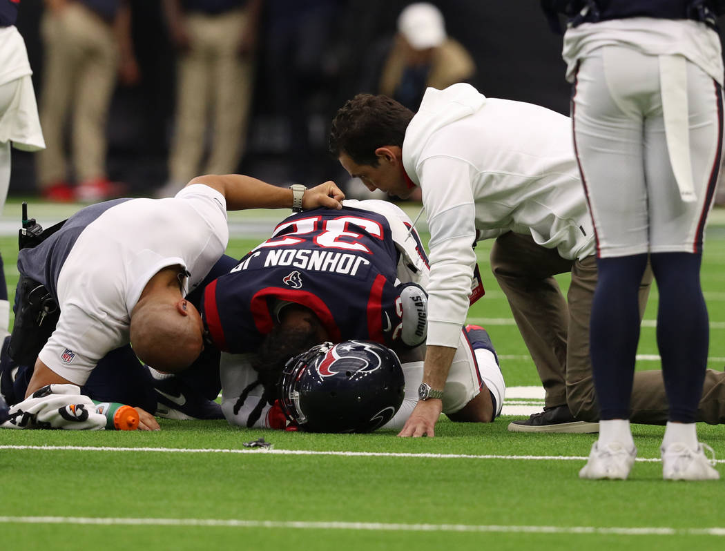 Houston Texans cornerback Lonnie Johnson (32) is evaluated by trainers after being injured duri ...