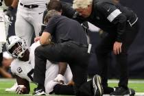 Trainers examine Oakland Raiders center Rodney Hudson (61) after he sustained an injury on a pl ...