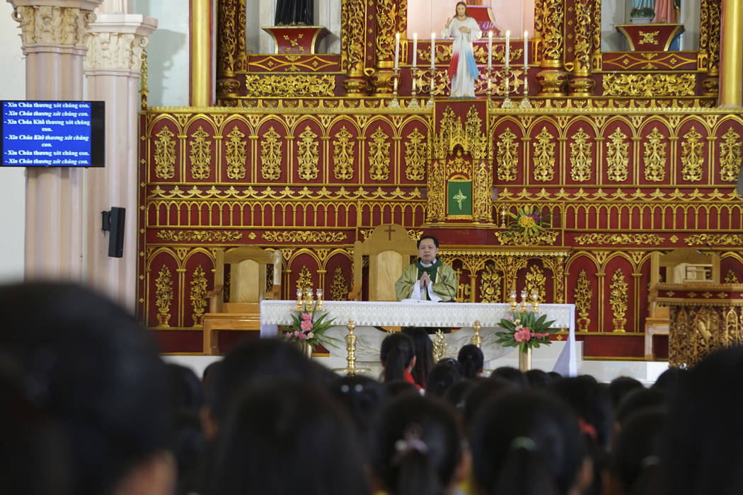 Priest Nguyen Duc Vinh prays as he leads a Sunday Mass at Phu Tang church in Yen Thanh district ...