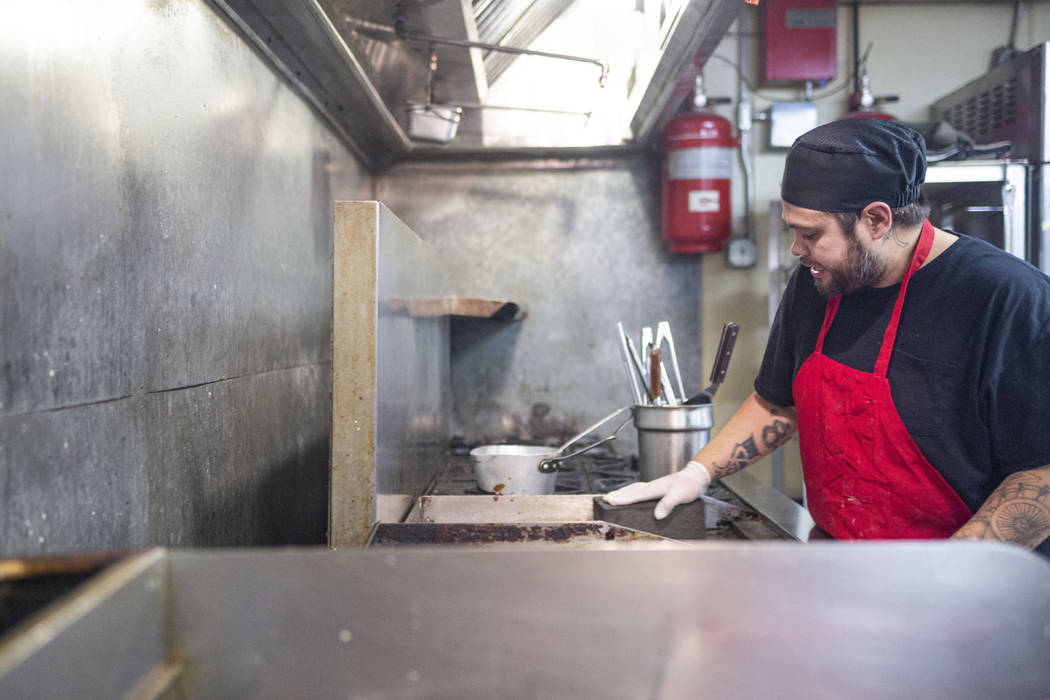Crown & Anchor Pub line cook Jacob Trujillo works while sharing his three different encounters ...