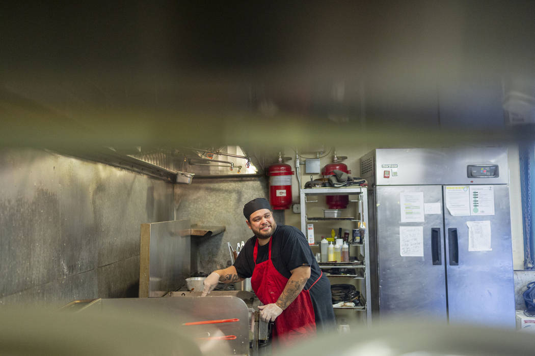 Crown & Anchor Pub line cook Jacob Trujillo works while sharing his three different encounters ...