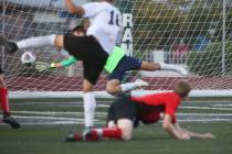 Las Vegas' Sergio Aguayo (18) scores against Coronado's Josue Ruiz during the Southern Nevada b ...