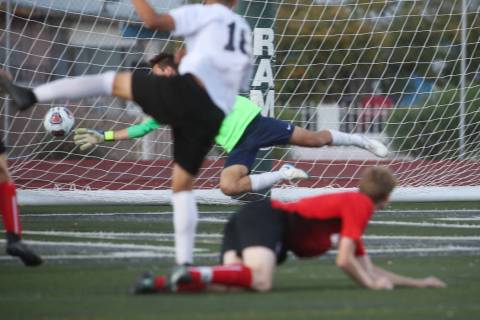 Las Vegas' Sergio Aguayo (18) scores against Coronado's Josue Ruiz during the Southern Nevada b ...