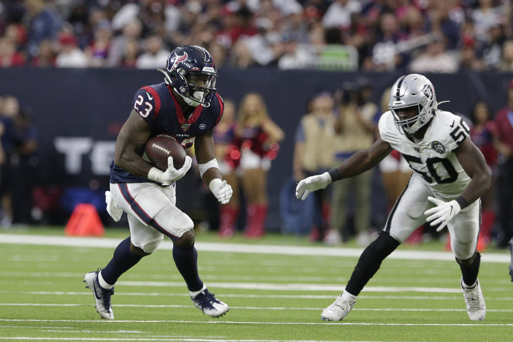 Houston Texans running back Carlos Hyde (23) and Oakland Raiders linebacker Nicholas Morrow (50 ...