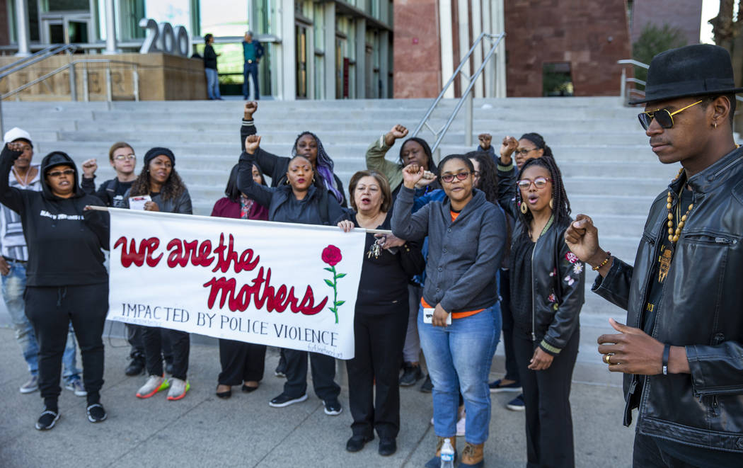 Rev. Stretch Sanders, right, offers some words of strength during the National Day of Outrage r ...