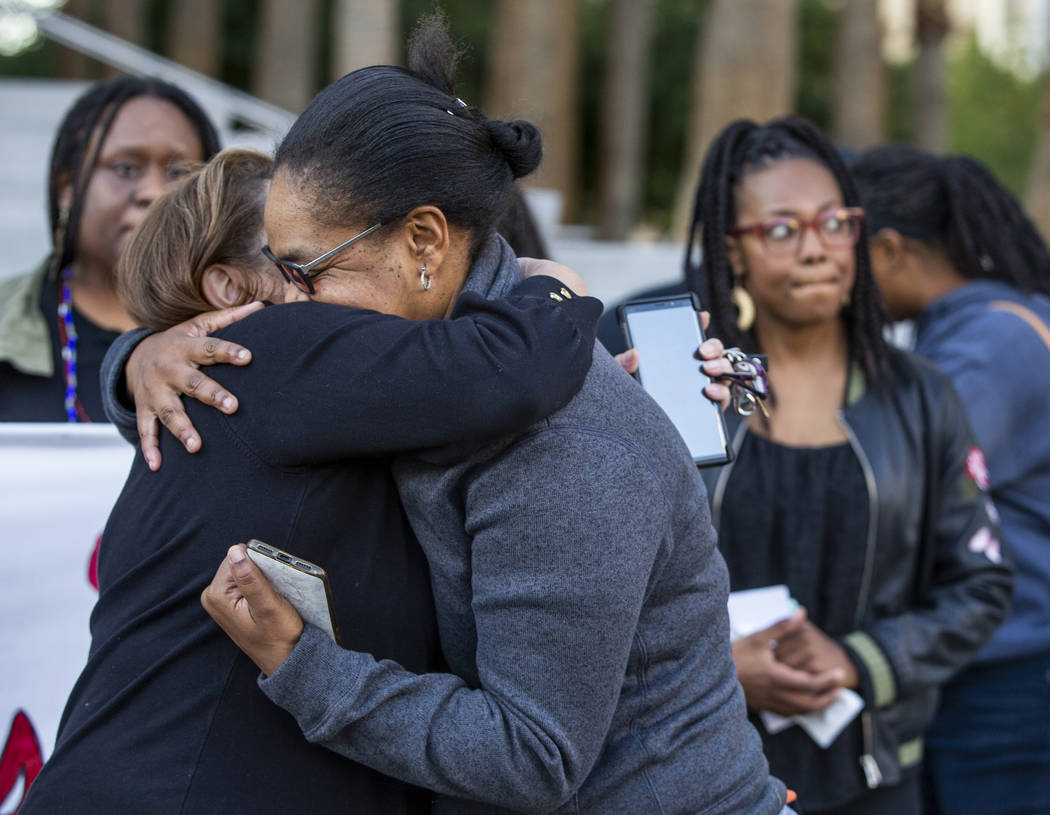 Kelly Williams, right, is hugged by Alma Chavez after speaking during the National Day of Outr ...