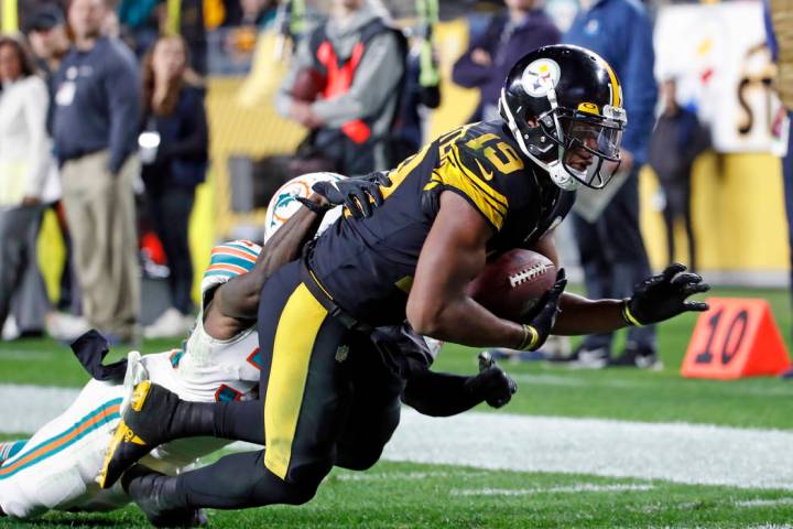Pittsburgh Steelers wide receiver JuJu Smith-Schuster (19) falls into the end zone for a touchd ...