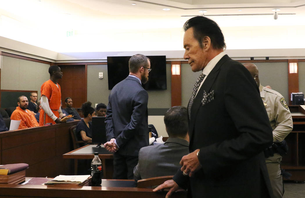 Wayne Newton, right, gets back to his seat after delivering his victim impact statement to the ...