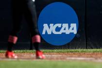 An athlete stands near a NCAA logo during a softball game in Beaumont, Texas. (AP Photo/Aaron M ...