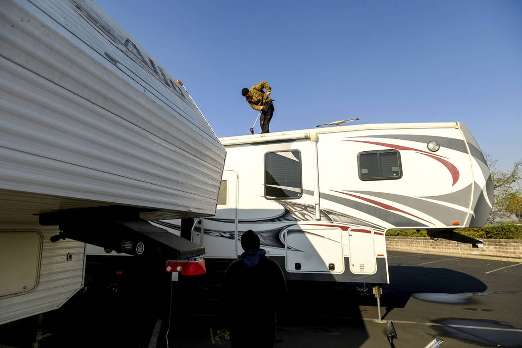 Kincade Fire evacuee Darrin Dailey cleans his recreational vehicle while camped in a Rohnert Pa ...