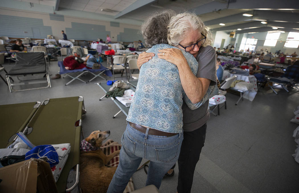 In this Sunday, Oct. 27, 2019, photo, Red Cross volunteer Barbara Wood gives a hug to a Kincade ...