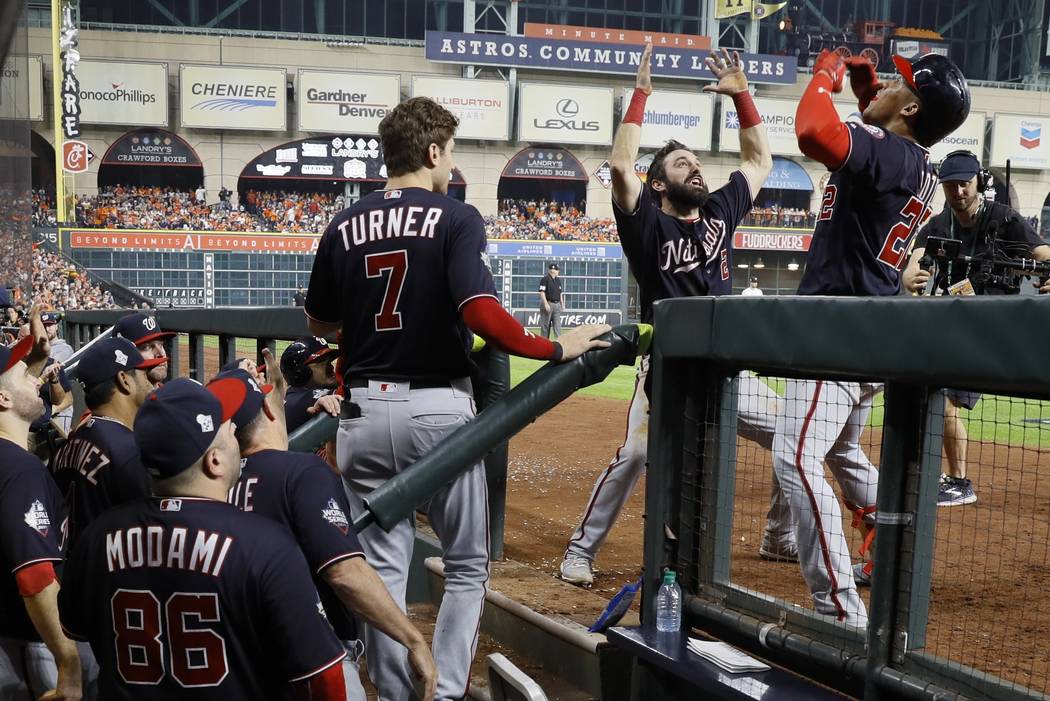 Washington Nationals' Juan Soto is congratulated by Adam Eaton after hitting a home run during ...