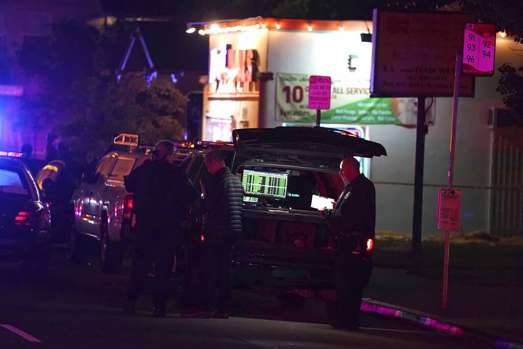 Police investigate the scene of a shooting on the E. 7th Street in Long Beach on Wednesday, Oct ...