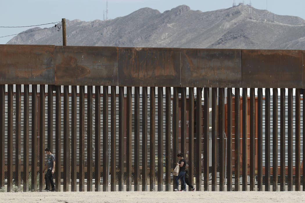FILE - In this July 17, 2019 file photo, three migrants who had managed to evade the Mexican Na ...