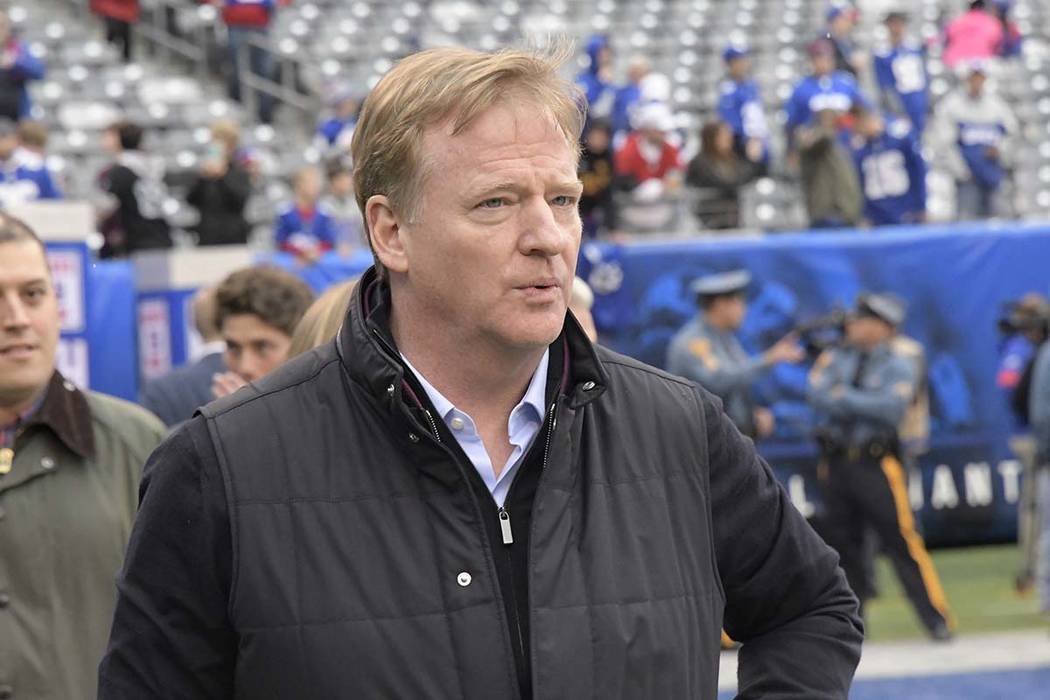 NFL Commissioner Roger Goodell walks on the field before an NFL football game between the New Y ...