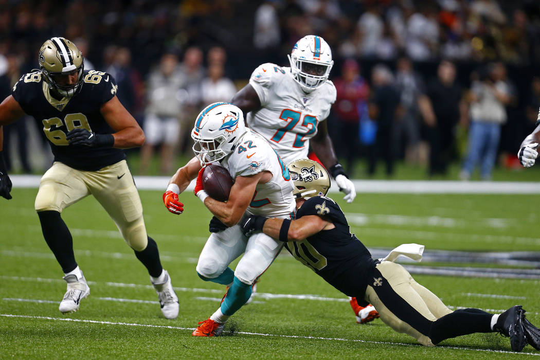 Miami Dolphins running back Patrick Laird (42) carries against New Orleans Saints inside lineba ...