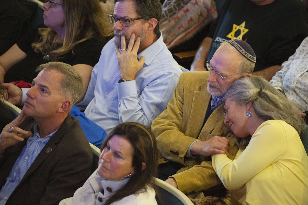 Daniel Leger, second from right, and his wife, Ellen Leger, embrace during the one-year commemo ...