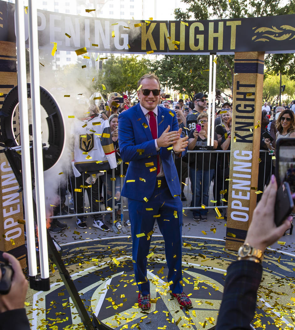 Vegas Golden Knights defenseman Nate Schmidt is showered by confetti about fans while walking t ...