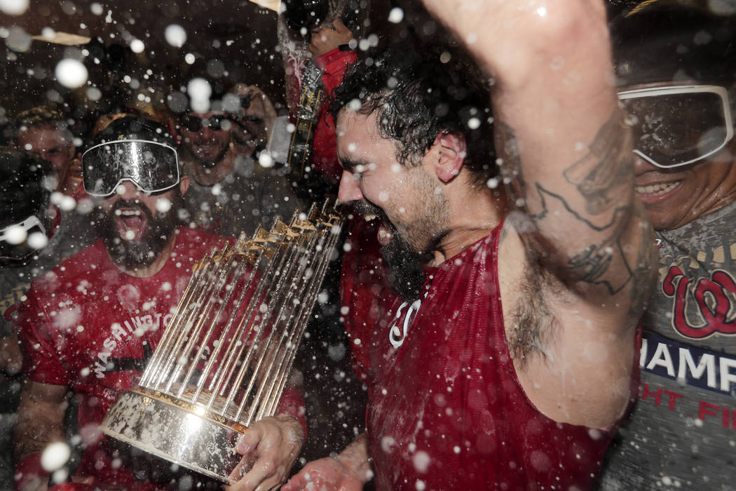 Washington Nationals third baseman Anthony Rendon and Adam Eaton celebrate in the locker room a ...