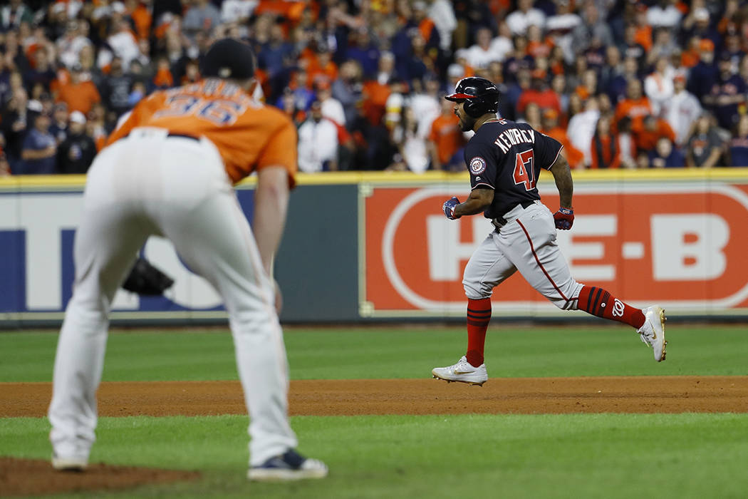 Houston Astros relief pitcher Will Harris watch as Washington Nationals' Howie Kendrick reacts ...