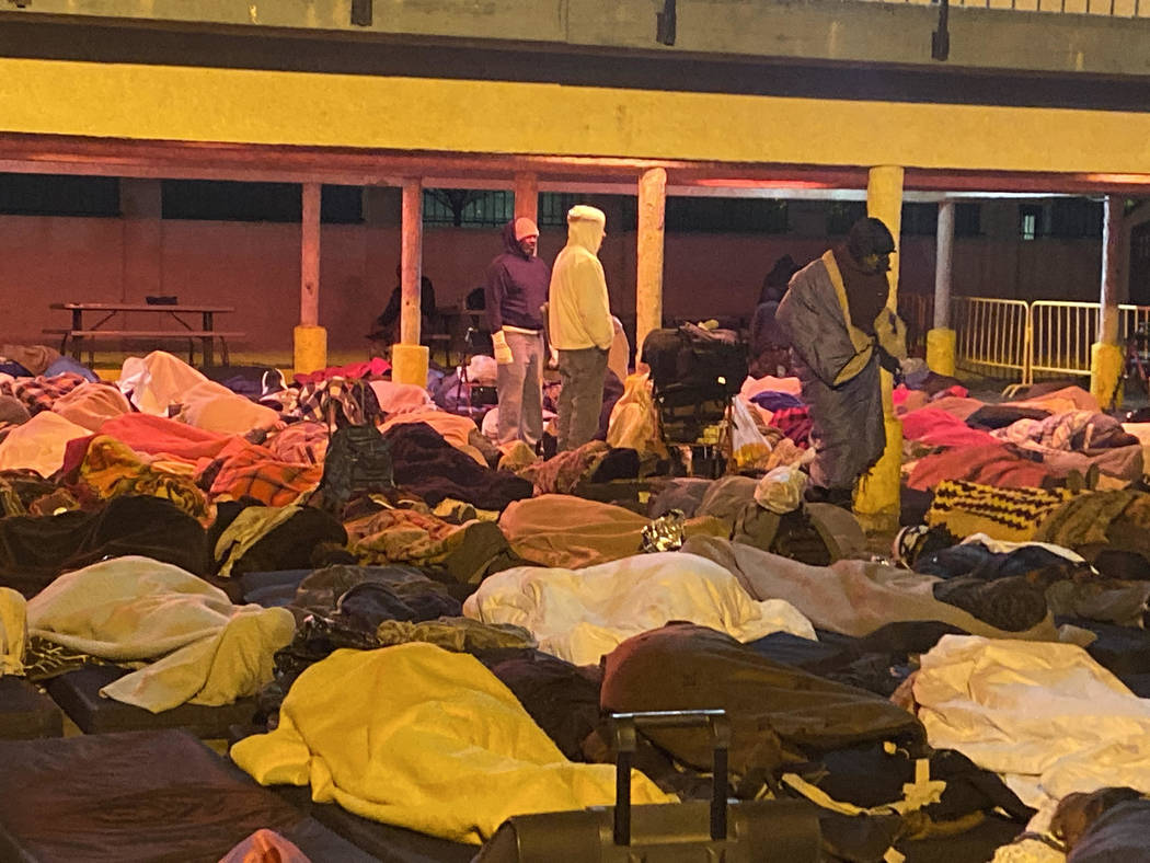 Homeless people rise early Thursday, Oct. 31, 2019, after spending the night at the city of Las ...