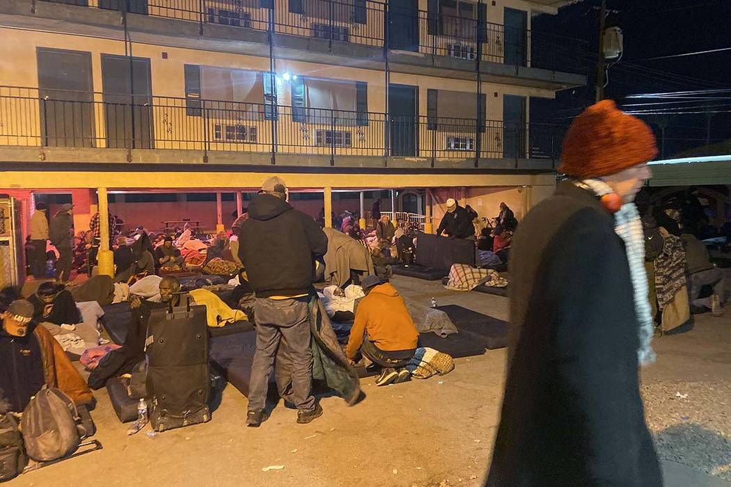 Homeless people rise early Thursday, Oct. 31, 2019, after spending the night at the city of Las ...