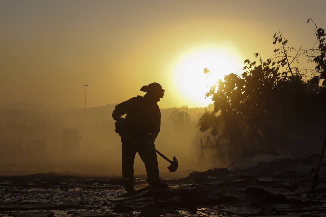 A firefighter puts out hotspots in Simi Valley, Calif., Wednesday, Oct. 30, 2019. (AP Photo/Rin ...
