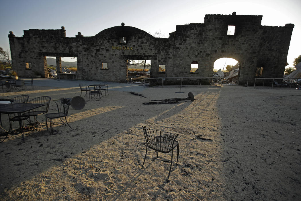 Charred remains of the Soda Rock Winery are framed by the building's stone facade in the afterm ...